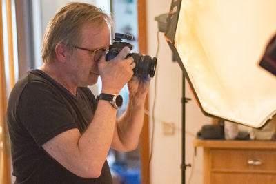 Side view of a man photographing