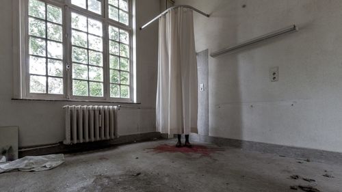 Boots and blood behind hospital curtain