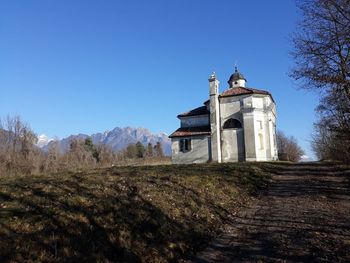 Church by building against clear blue sky