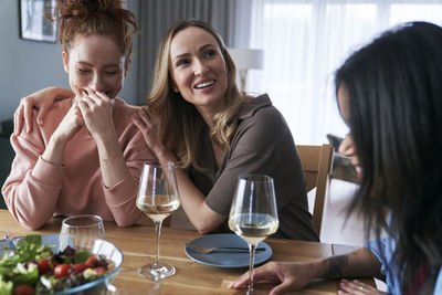 Portrait of young woman having food at home