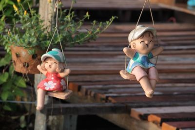 Close-up of child toys swinging at yard