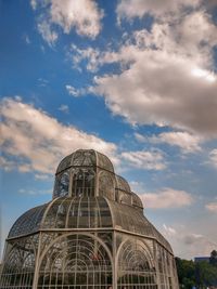 Low angle view of building against cloudy sky