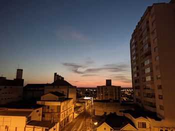 High angle view of buildings in city at sunset