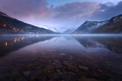 Scenic view of snowcapped mountains against sky at night