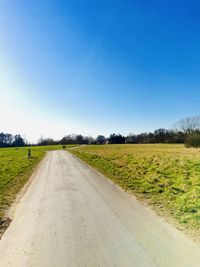Empty road along countryside landscape