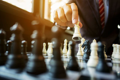 Close-up of man playing with chess