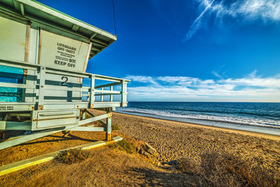 Scenic view of beach against blue sky