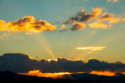 Low angle view of dramatic sky during sunset
