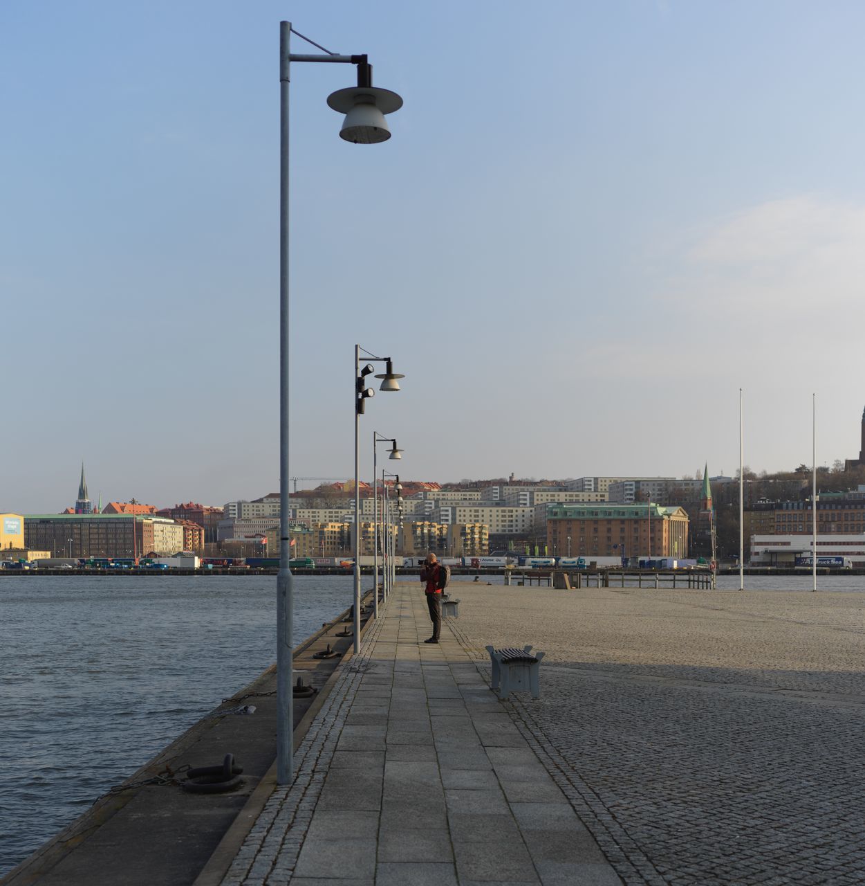 built structure, architecture, clear sky, building exterior, real people, sky, city, day, outdoors, water, men, one person