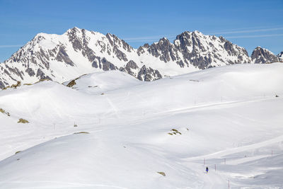 Scenic view of snow covered mountains against sky