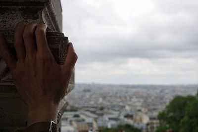 Cityscape against cloudy sky