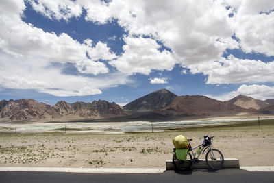 Rear view of people on road against sky
