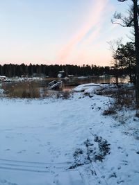 Scenic view of lake against sky during winter