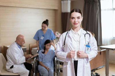 Portrait of female doctor examining x-ray