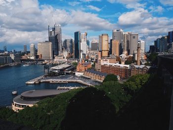 Aerial view of buildings in city against sky