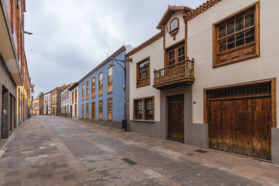 Street amidst buildings against sky