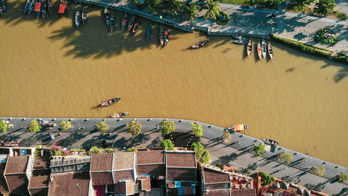 High angle view of people at beach against buildings in city