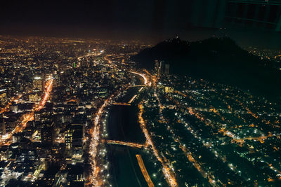 High angle view of illuminated city buildings at night