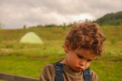 Portrait of boy looking away outdoors