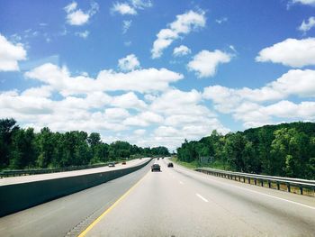 Cars on road against sky