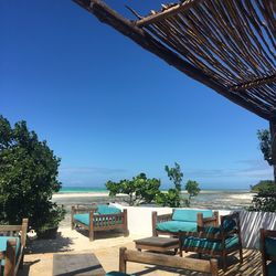 View of swimming pool by sea against clear blue sky