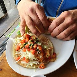 Cropped image of person holding food