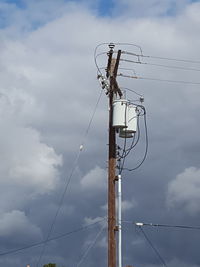 Low angle view of electricity pylon against sky