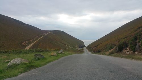 Empty road along countryside landscape