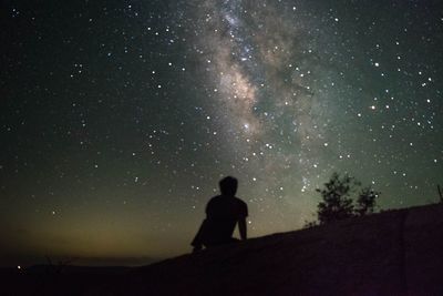 Silhouette of trees against sky at night