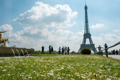 Low angle view of eiffel tower against cloudy sky