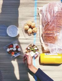 Cropped image of woman having food at table