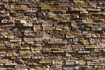 Decorative relief cladding slabs imitating stones on wall.