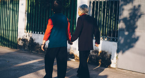 Close-up of people walking on footpath