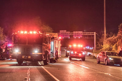 Vehicles on road in city at night