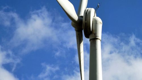 Low angle view of windmill against sky