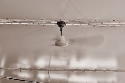 Low angle view of lighting equipment hanging from ceiling