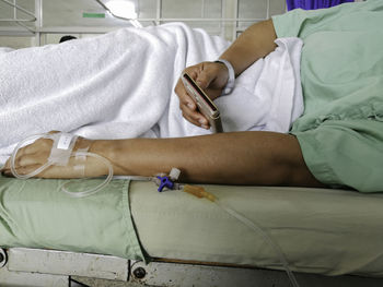 Midsection of woman lying on bed
