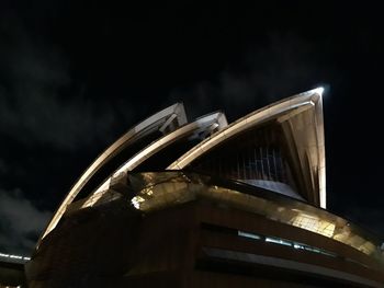 Low angle view of illuminated ferris wheel against sky at night