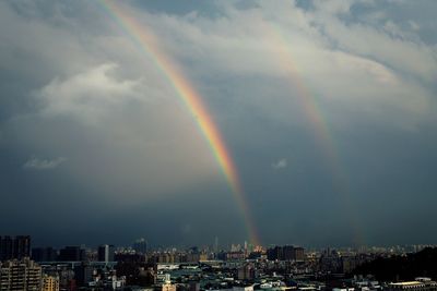 Rainbow over city at night