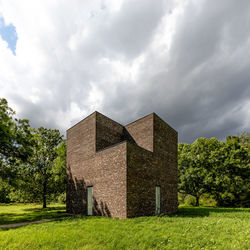Built structure on field against sky