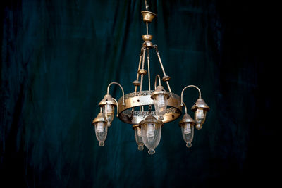 Close-up of illuminated pendant light hanging from ceiling