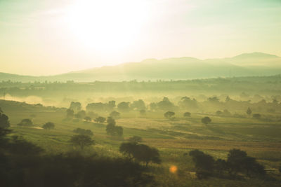 Scenic view of landscape against sky at sunset