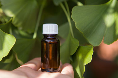 Close-up of hand holding glass bottle