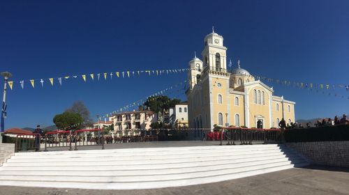View of church  buildings in city kalamata against clear blue sky
