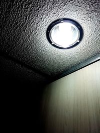 Low angle view of light bulb on wall