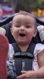 Close-up portrait of cute boy holding baby