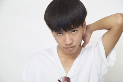 Portrait of mature man standing against white background