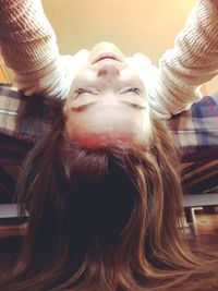 Low angle view of young woman lying on bed at home