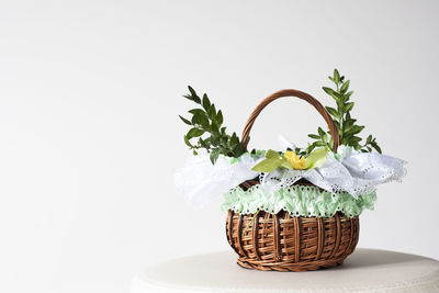 Flower vase on table against white background