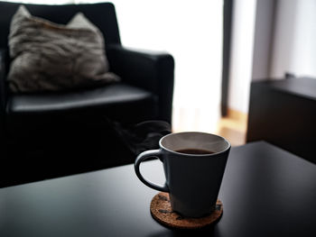 Close-up of coffee cup on table